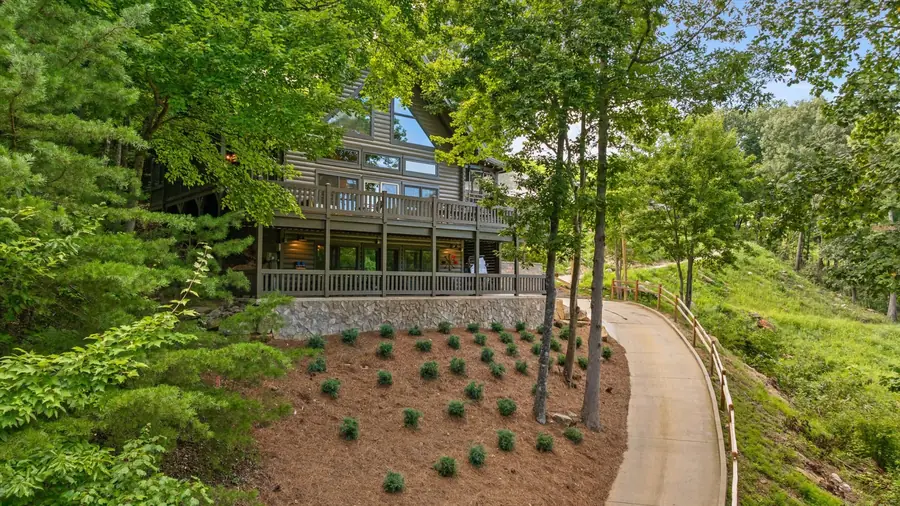 Aerial view of the home among trees with the drive below