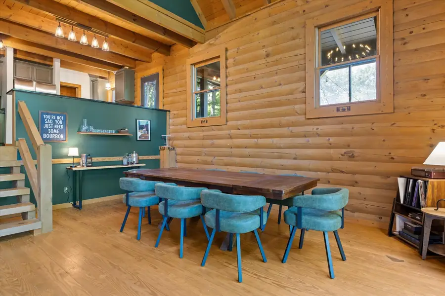 Round table with teal chairs next to the built-in bar