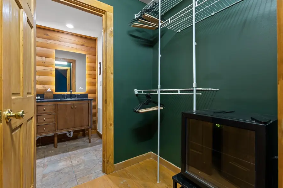 Bathroom with glass shower enclosure and forest green wall