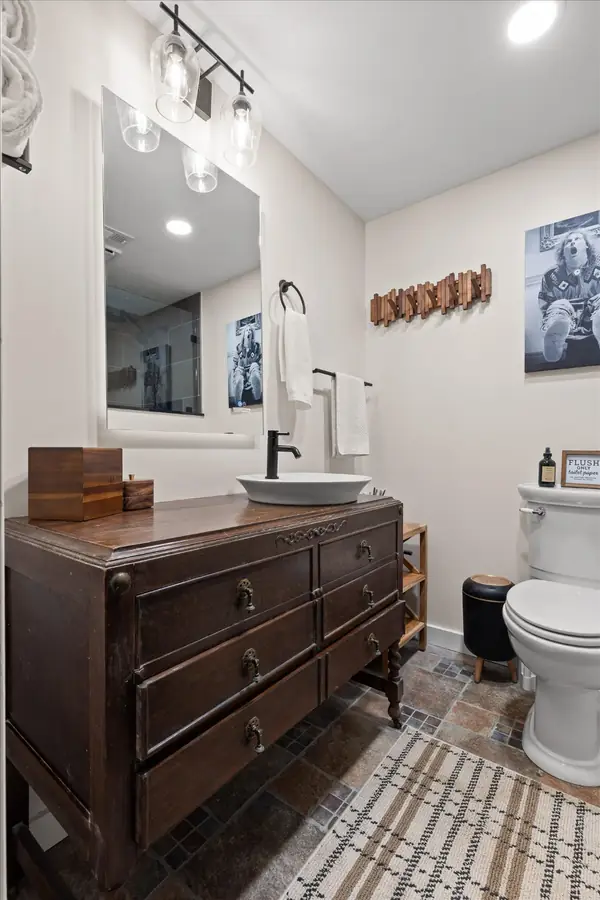 Bathroom with freestanding tub and dark wood vanity