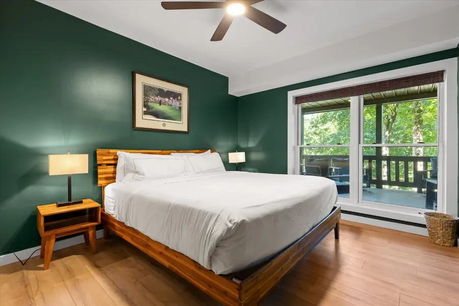 King bedroom on the lower level with windows to the trees