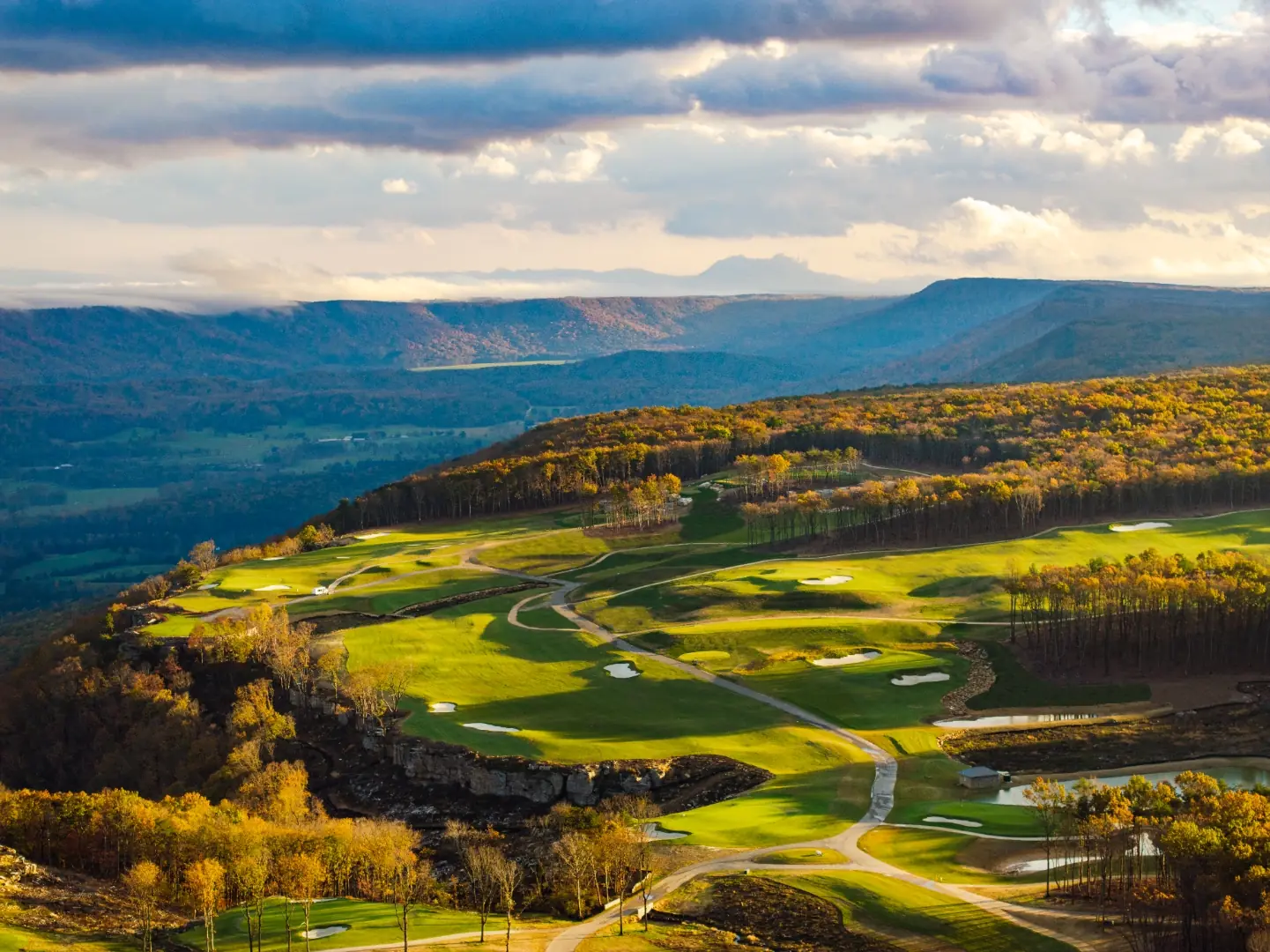 Autumn sunset over the McLemore course along the brow of Lookout Mountain, with fairways above the valley and ridgelines beyond