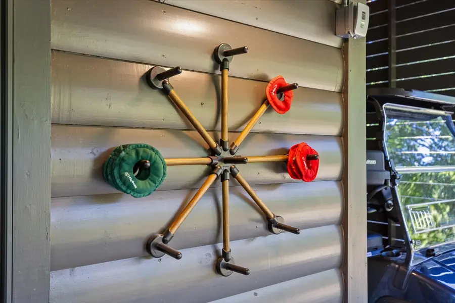 Corn hole boards and outdoor games hung on a log wall