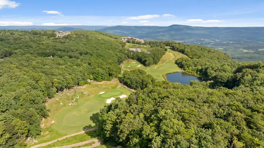 Golf hole with a pond and the valley stretching behind it
