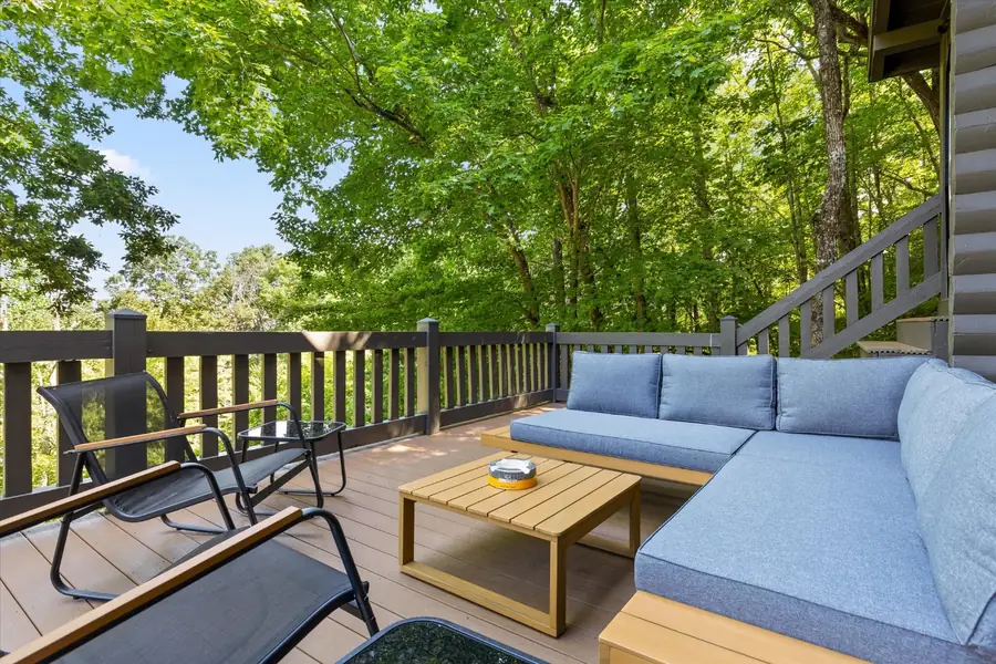 Cushioned outdoor sofa and wood table on the deck