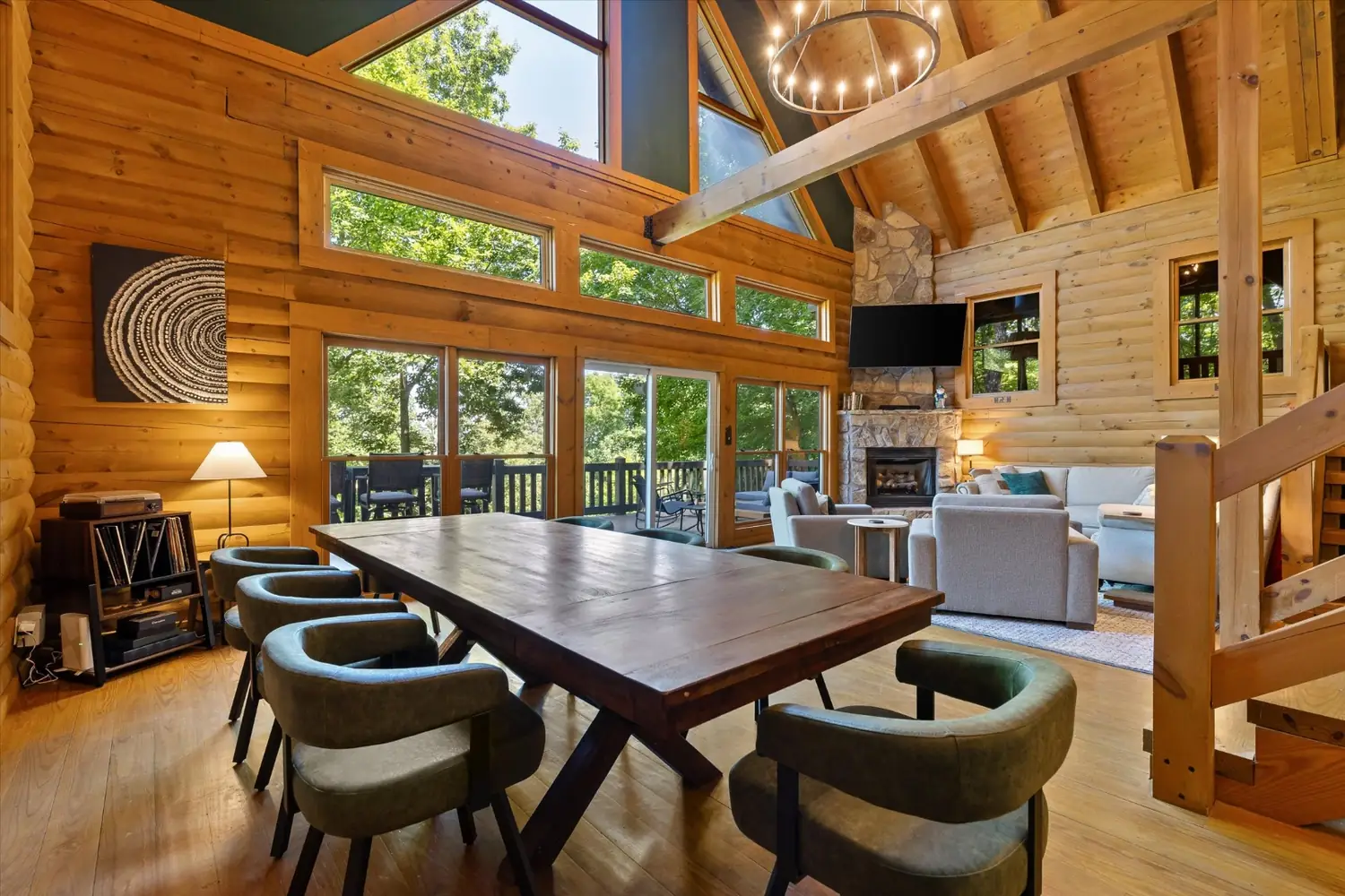 Open plan dining and living space with a wall of windows to the deck