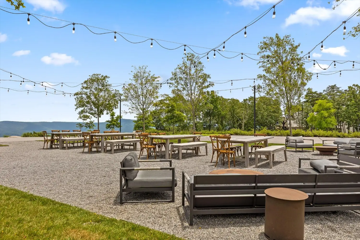 Outdoor fire pit lounge with string lights overlooking the valley at McLemore