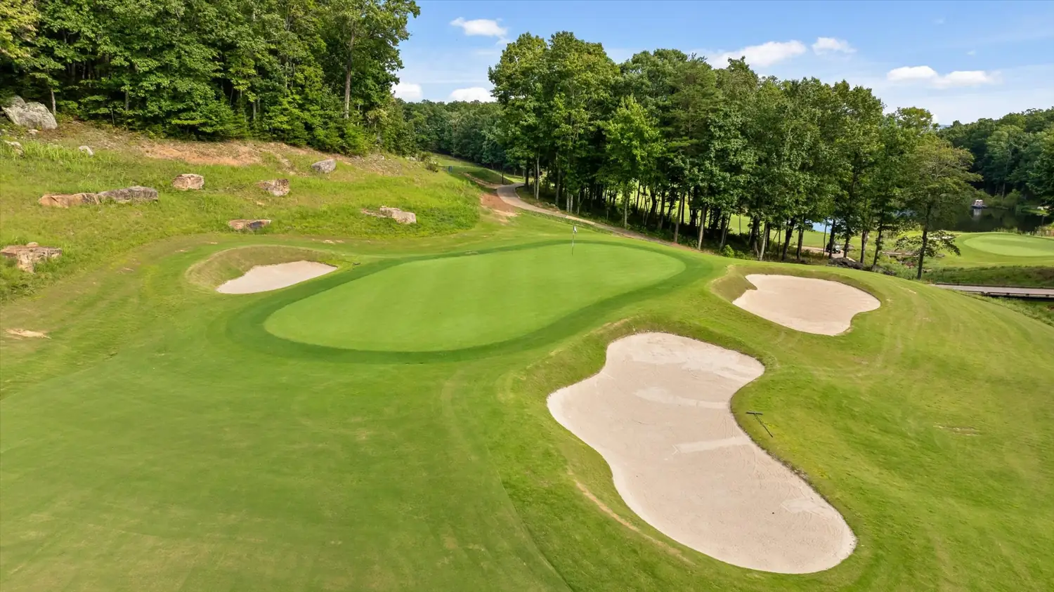 A green ringed by sand bunkers on the McLemore course