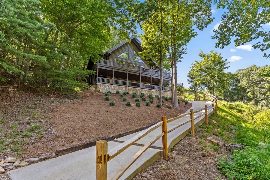 Side view of the home with a wood fence and landscaped beds