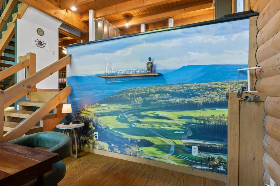 Walnut dining table in front of the floor to ceiling mural of The Keep