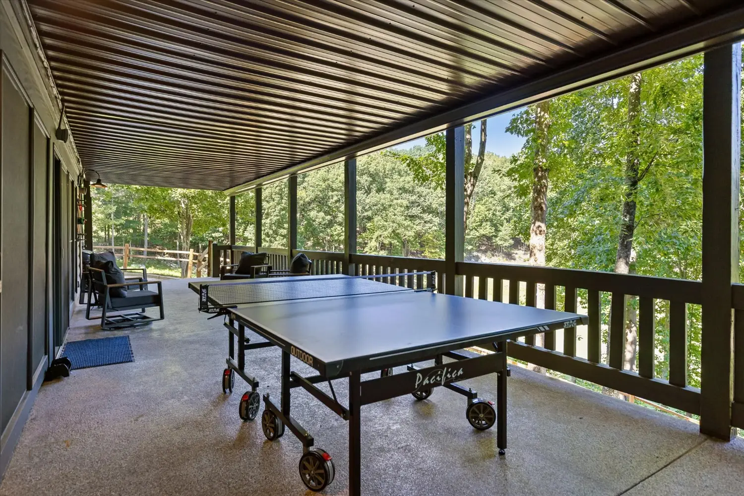 Ping pong table on the covered lower patio, open to the trees