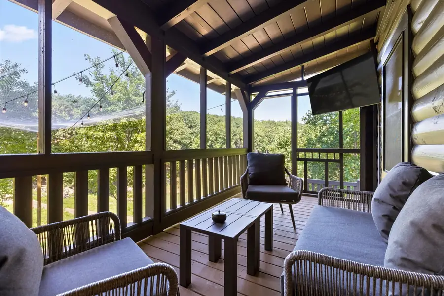 Covered porch with armchairs and a small table