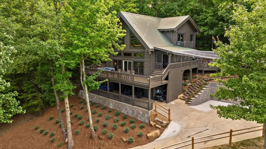 Rear aerial of the home showing three levels of decks