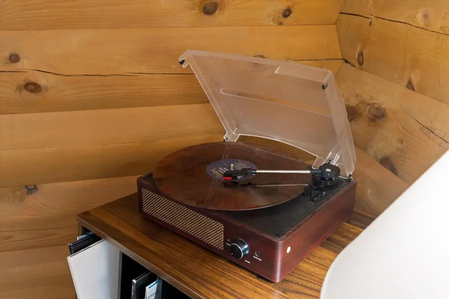 Vintage turntable open on a wooden cabinet